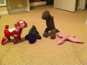 stuffed dog and dinosaurs